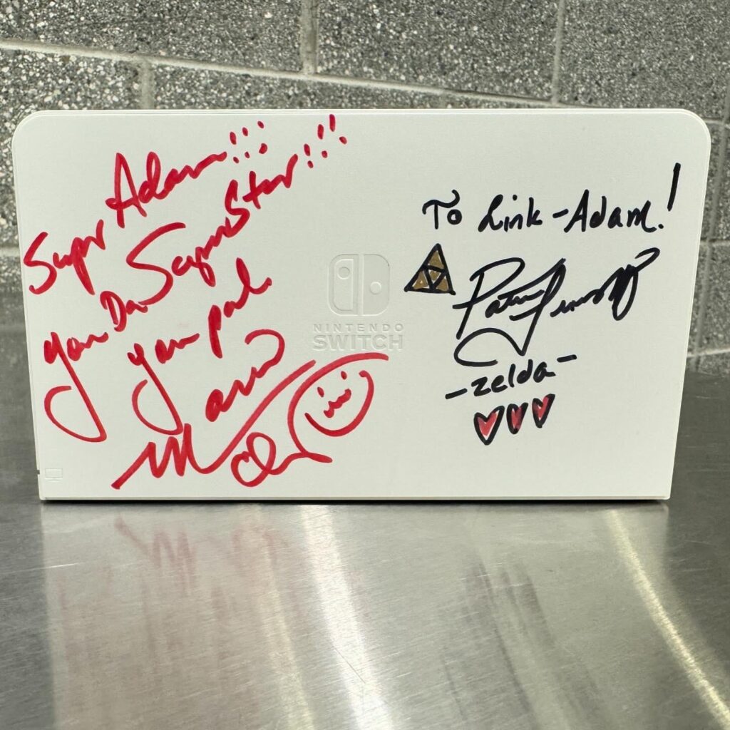 Got the voice actors who portrayed Mario and Zelda to sign my Switch dock!
