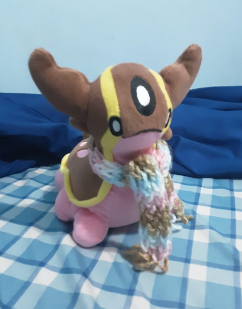 My lil' 10 yo sister knitted a scarf for my Gastrodon plushie