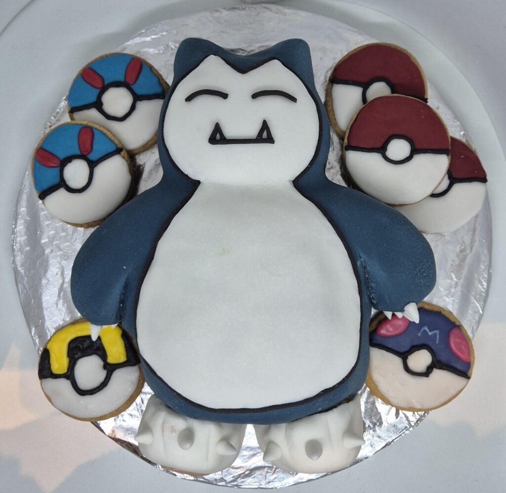 Lemon Snorlax cake with iced Pokéball biscuits I made for my coworker 😊