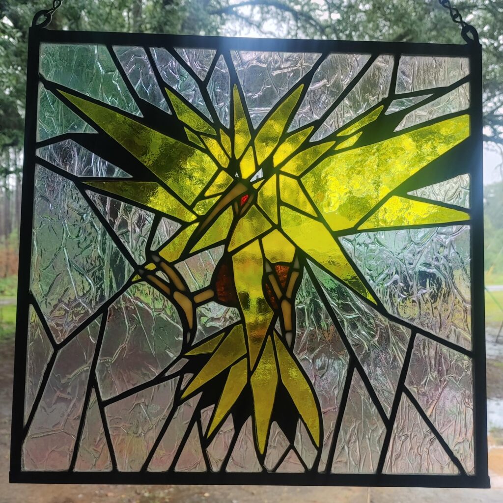 Stained Glass Zapdos I did as my third project in 2016. Recently cleaned up and still with me after all these years.