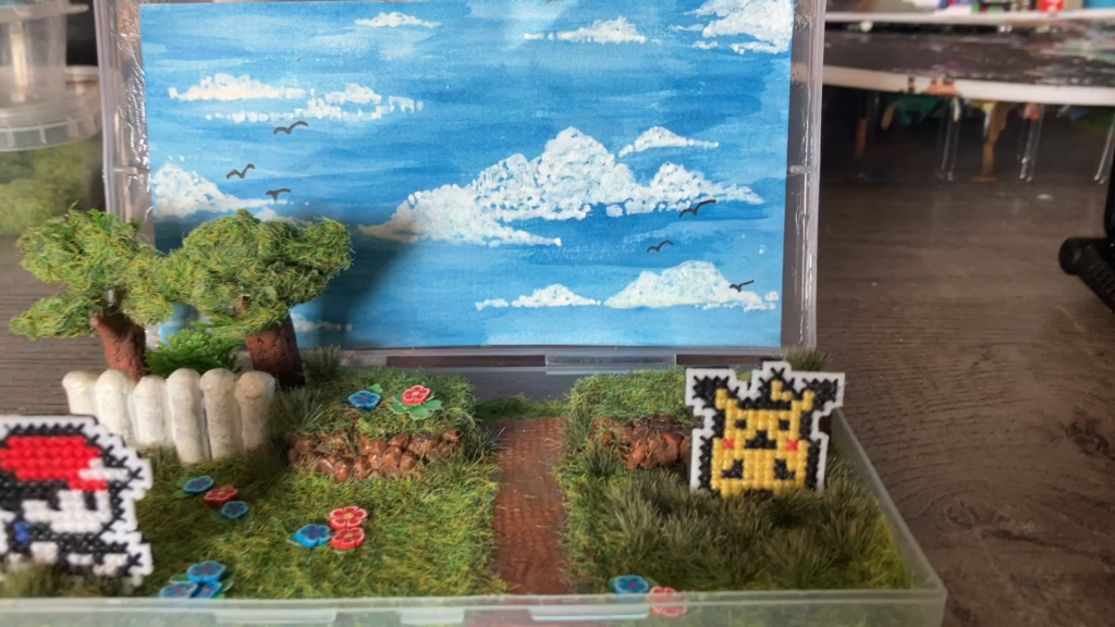 I made a Pokemon Yellow-inspired cross stitch piece!