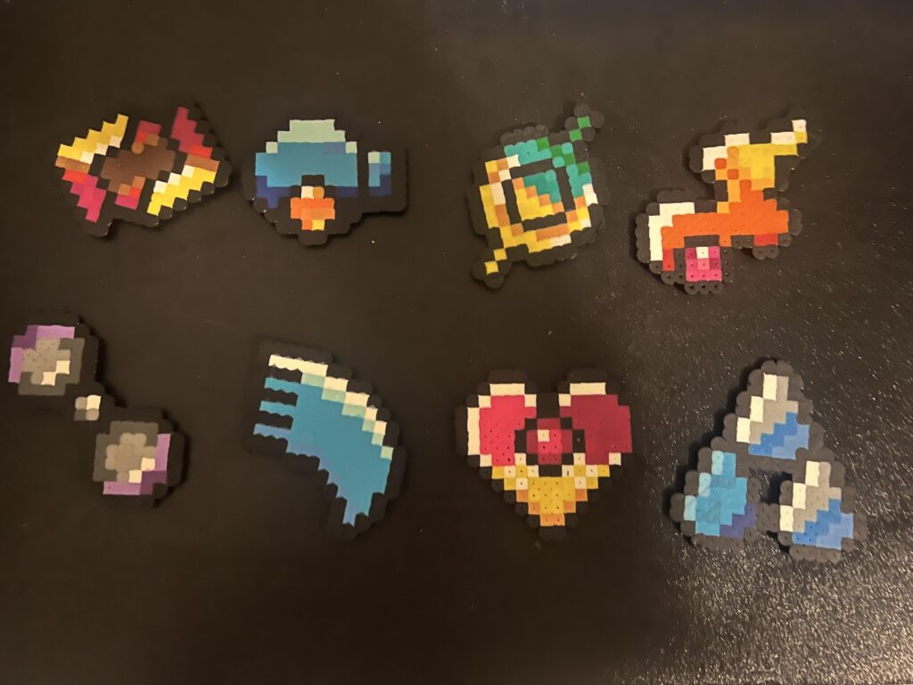 I made perler bead Hoenn gym badges