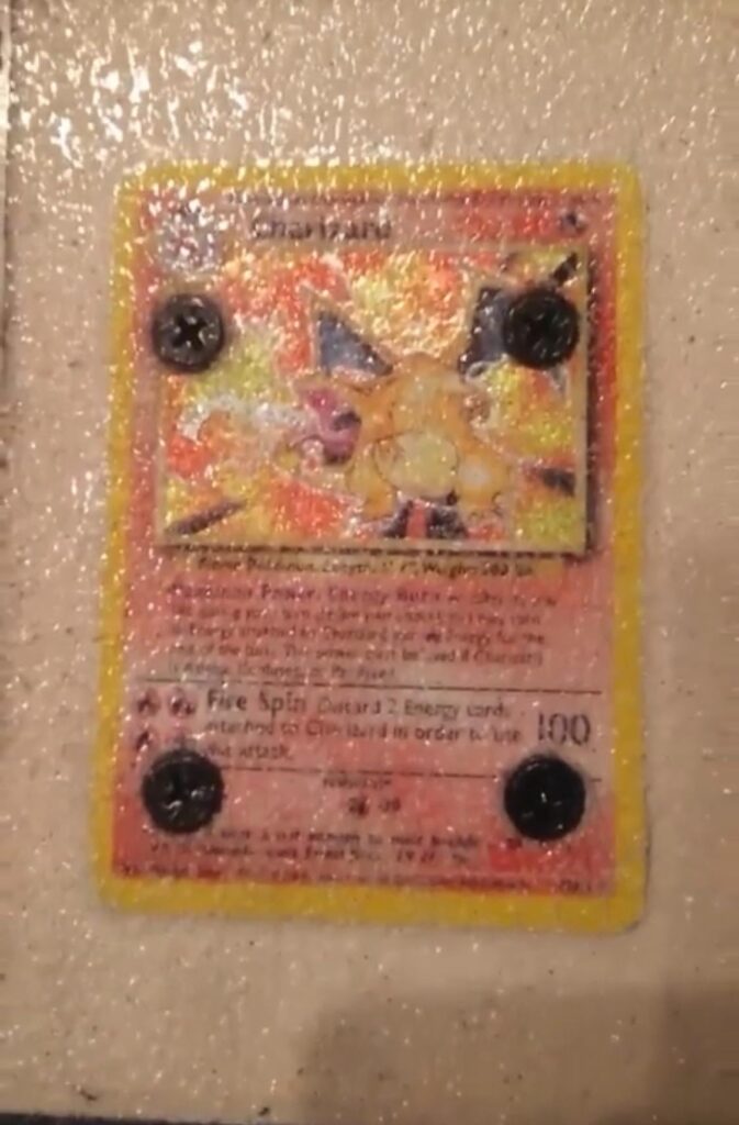 found this pic from 2018 in high school when i threw my base set charizard under clear grip for my board setup