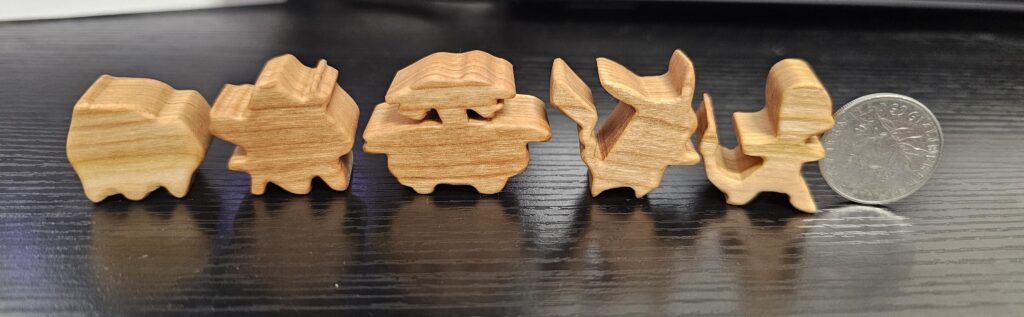 (OC)My first attempts at teeny wooden pokemon. Random foreign coin I thought was a quarter for scale.
