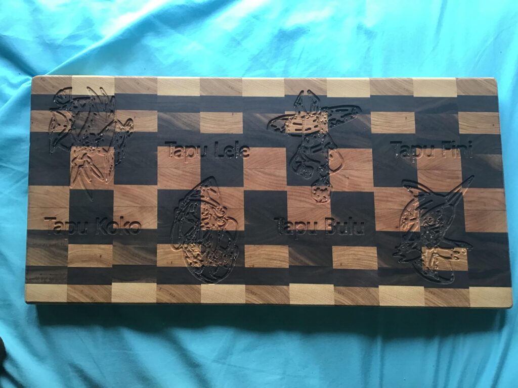 A cutting board I made with the Tapus on it