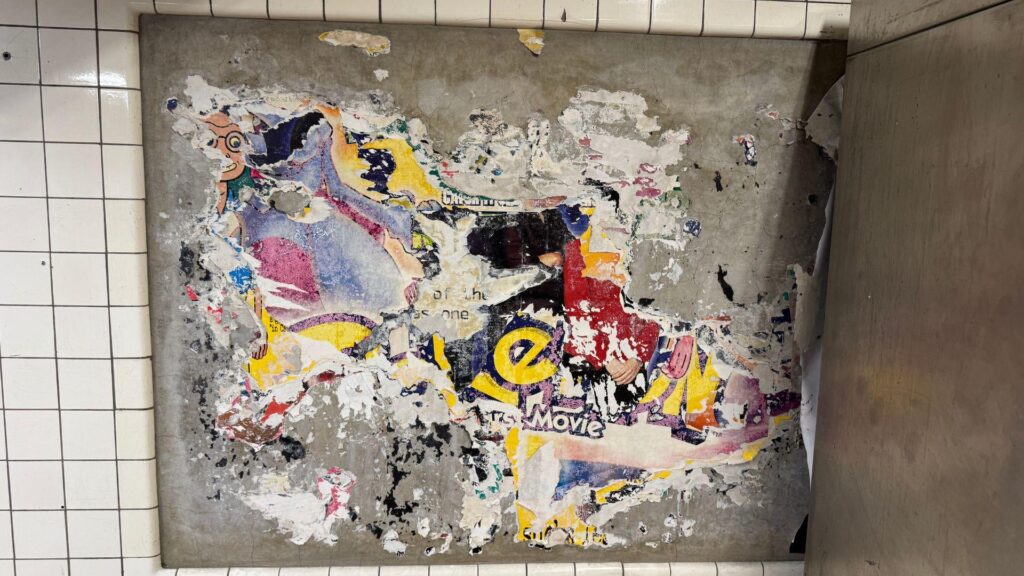 A poster for "Pokémon: The First Movie" (1999) was discovered at the East Broadway F train subway station, hidden beneath decades of posters that had been pasted over it and a MetroCard machine which was recently removed.