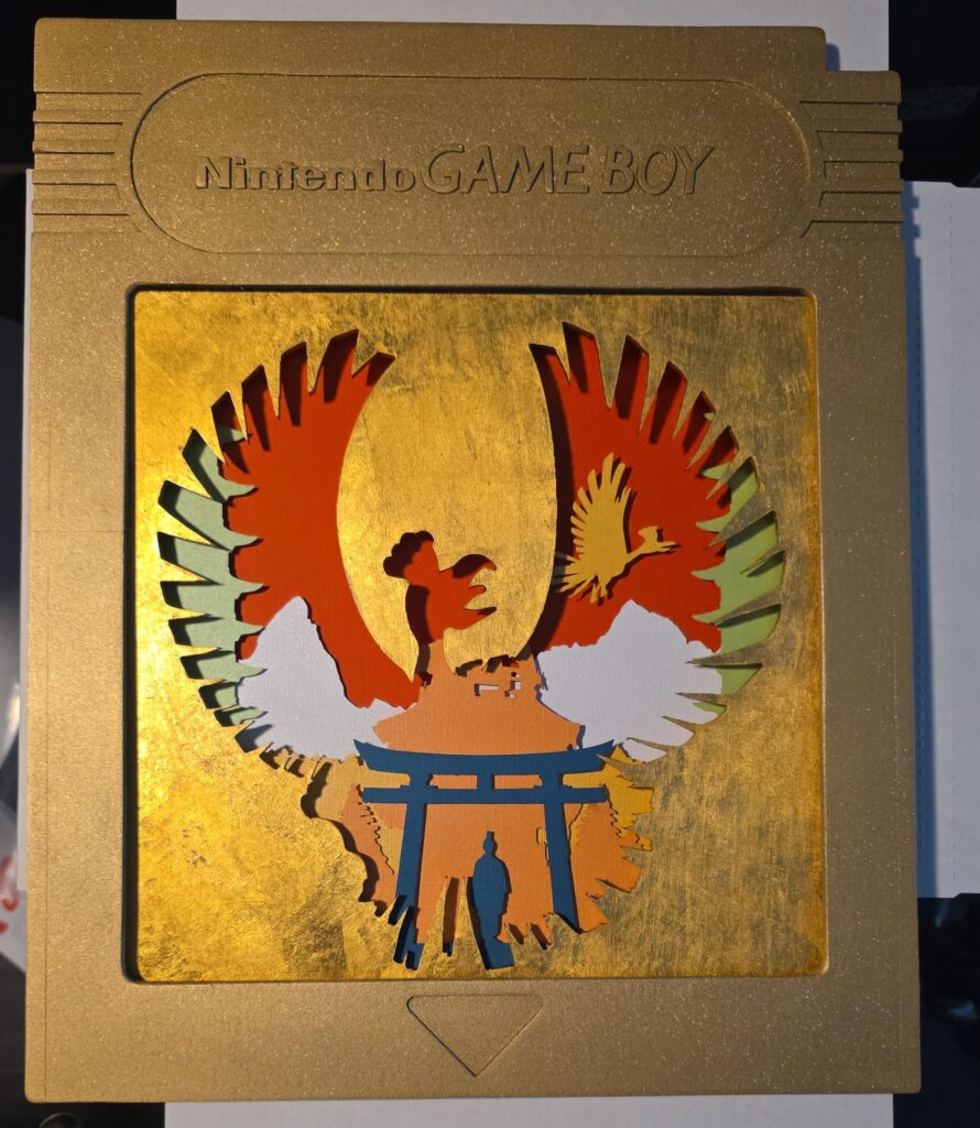 [OC] Wanted to make a super special version of some of my johto designs. Tried to recreate the original cartridge as a frame and the face of the actual design is covered in 24k gold.