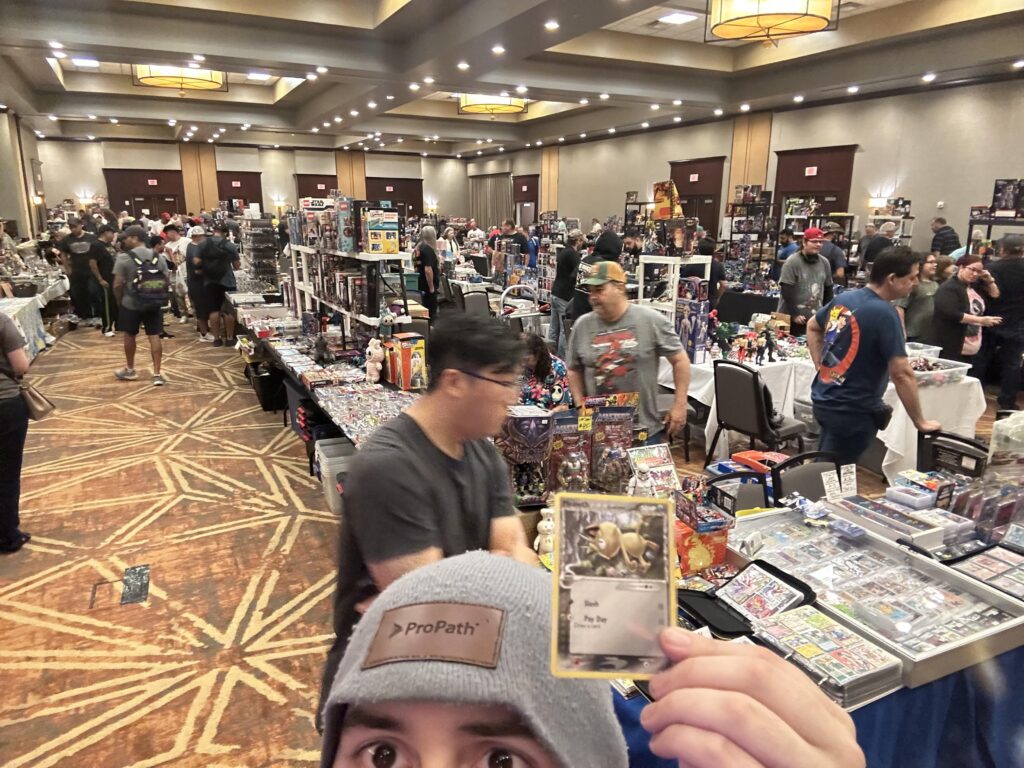 At a card/toy/collectibles show in Allen, Texas and found a Meowth card to add to my collection!