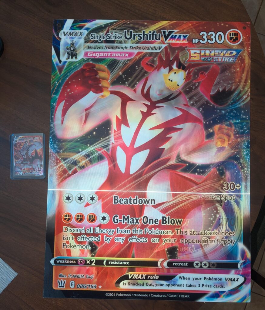 Any Urshifu die hards out there? Got this jumbo promo card a few years back. Regular Urshifu Vmax for scale