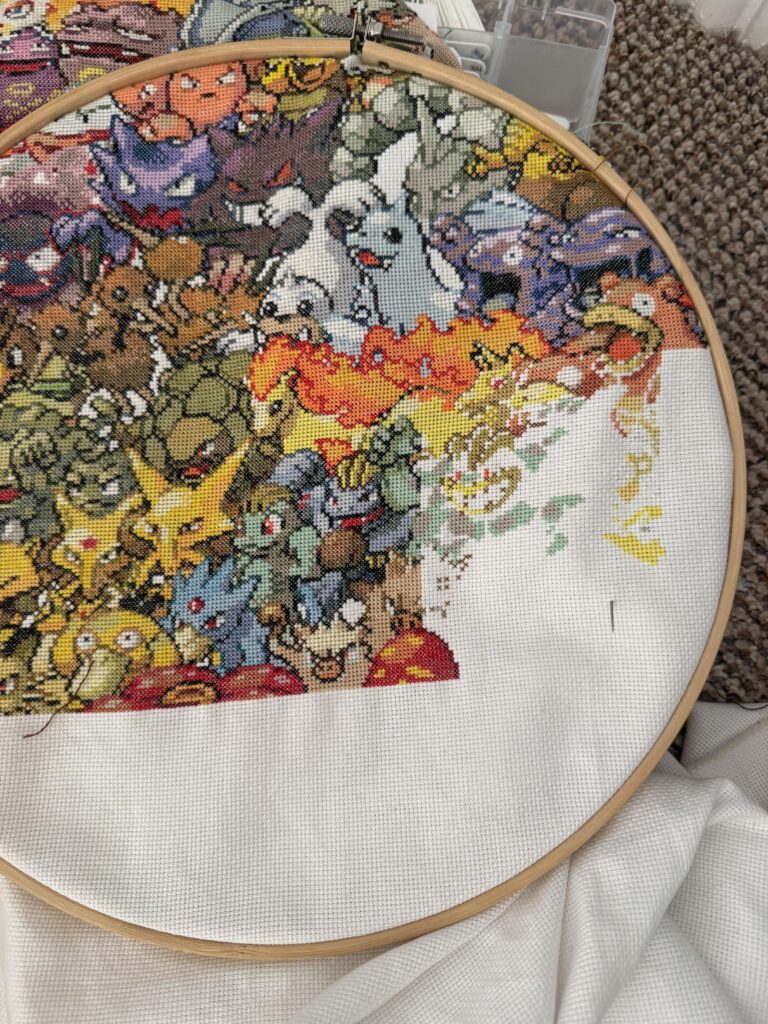 Working through page 18 of my cross stitch and why does Machamp have a chicken head? :/
