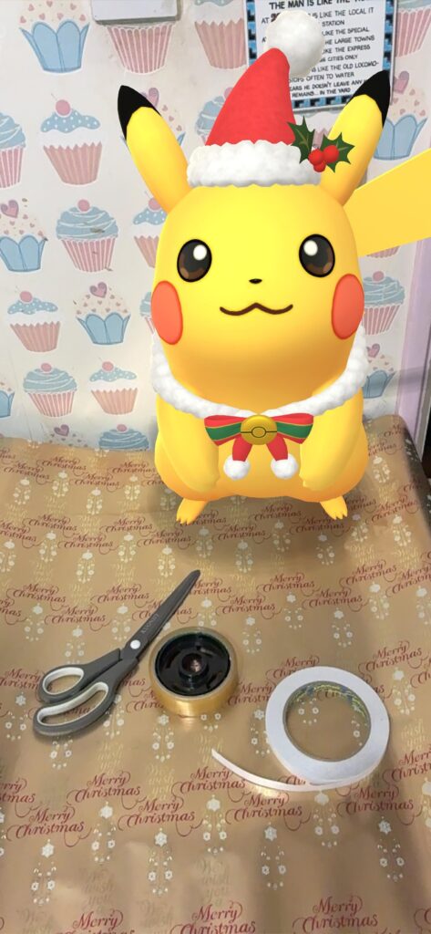 Got Pikachu to hold the wrapping paper flat..