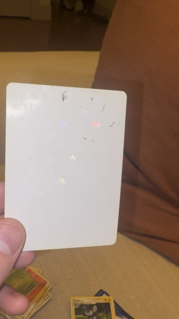 My mom sent me my old card collection. Need some help IDing this i suspect it’s an error reverse holo from EX hidden legends….