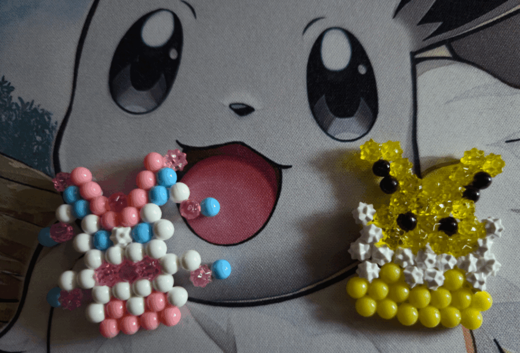 Sylveon and Jolteon that my 9 year old made from Aquabeads