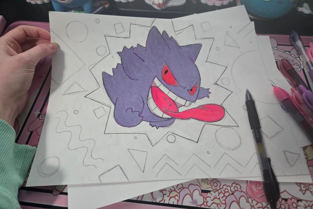 Gengar drawing with pen.