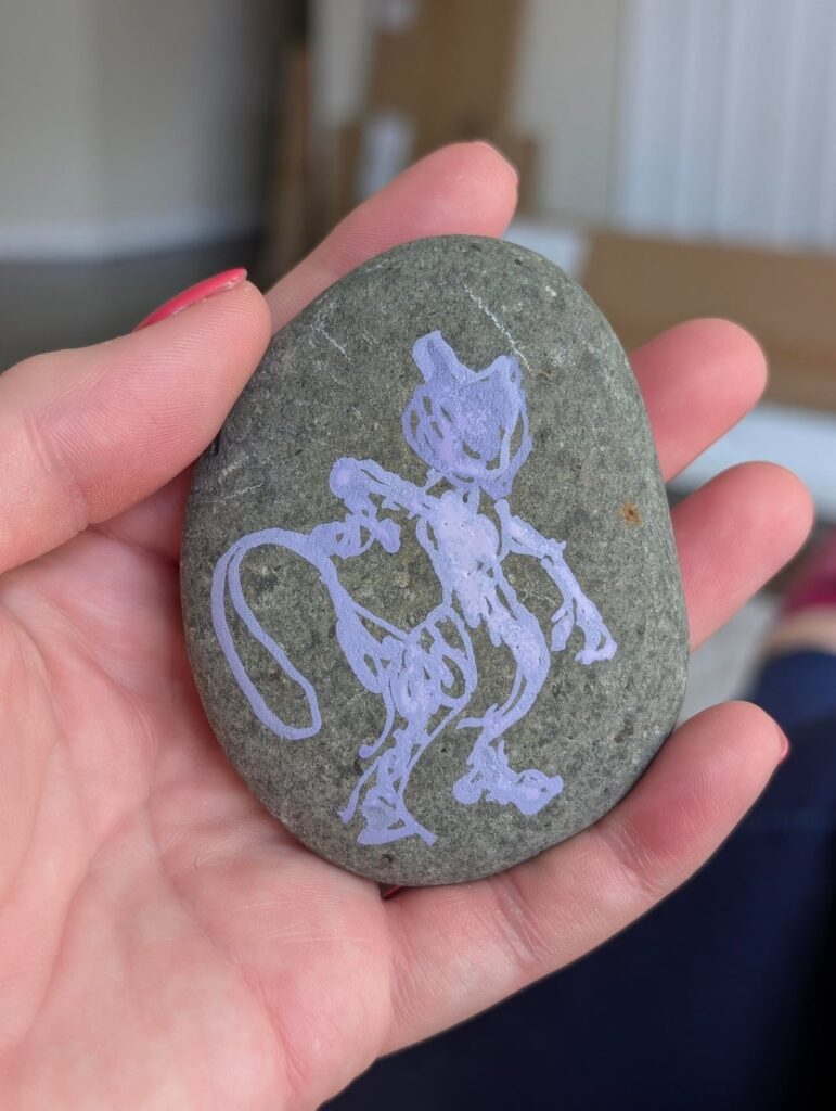 Please enjoy the meandering process I took painting Mewtwo onto a rock.