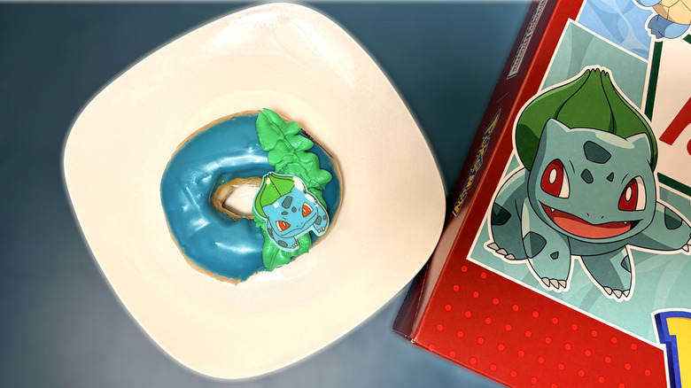 bulbasaur themed doughnut on plate next to box